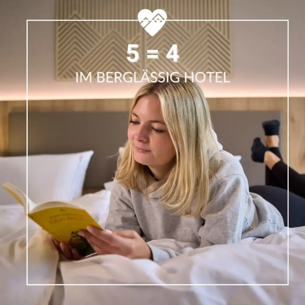 Frau liegt auf einem Bett und liest ein Buch mit dem Text "5 = 4 im Bergl&auml;ssig Hotel" &uuml;ber ihr.